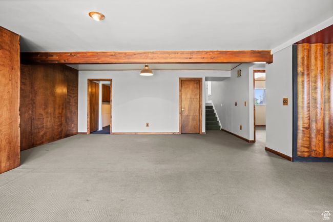 Carpeted spare room with beamed ceiling and stairway | Image 28
