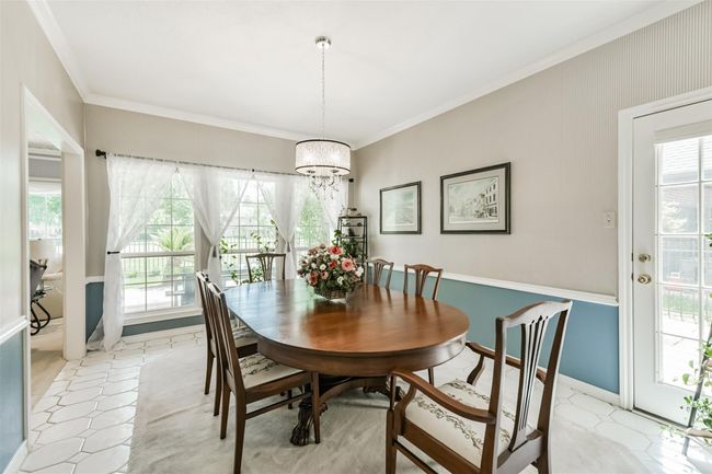 Formal Dining Room features amazing views as well as a door to the back patio | Image 11