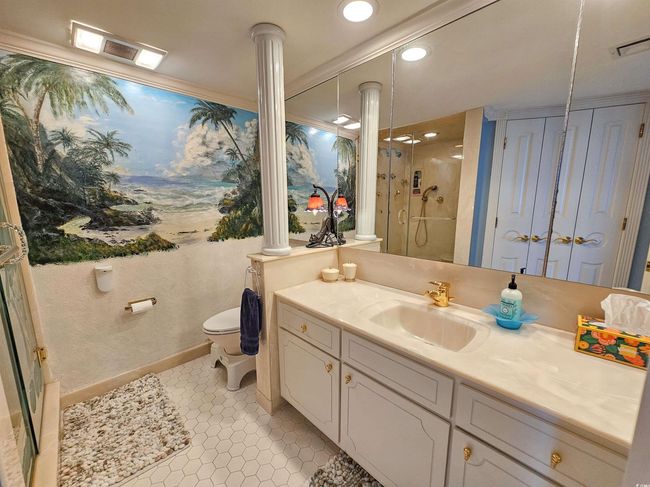 Bathroom with vanity, decorative columns, toilet, recessed lighting, and a stall shower | Image 34