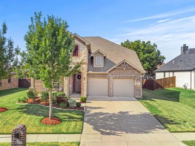 View of front of home featuring a garage and a front yard | Image 2