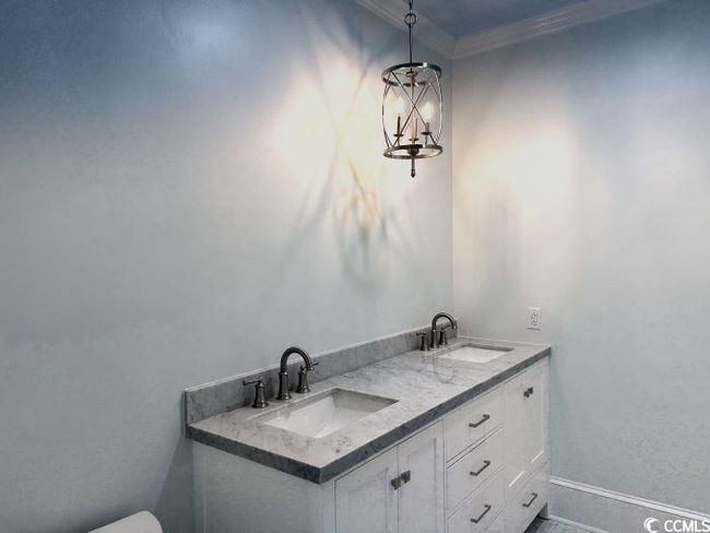 Bathroom featuring vanity and crown molding | Image 28