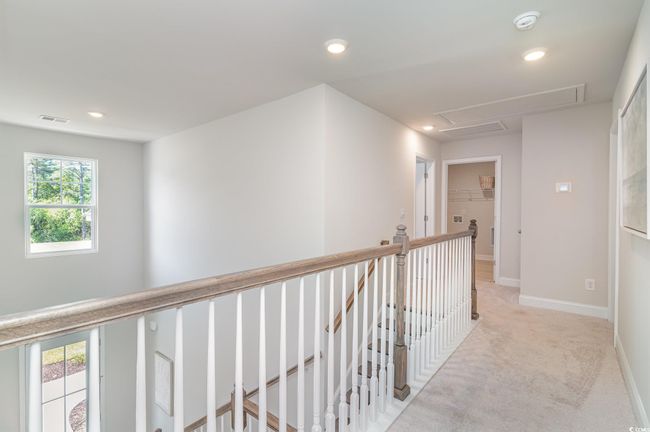 Hall with recessed lighting, visible vents, an upstairs landing, and light carpet | Image 15