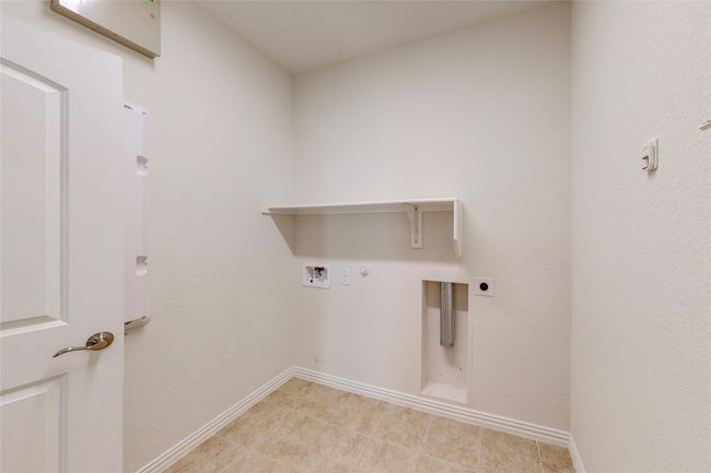 Washroom featuring hookup for an electric dryer, hookup for a washing machine, hookup for a gas dryer, and baseboards | Image 18