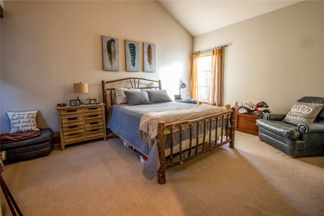 Carpeted bedroom featuring high vaulted ceiling | Image 18