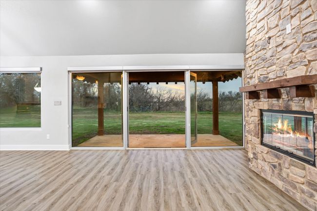 Doorway to outside with an outdoor stone fireplace and light wood-type flooring | Image 8