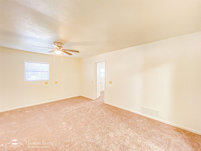 Unfurnished room with ceiling fan and light carpet | Image 8