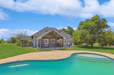 View of pool with a lawn | Image 2