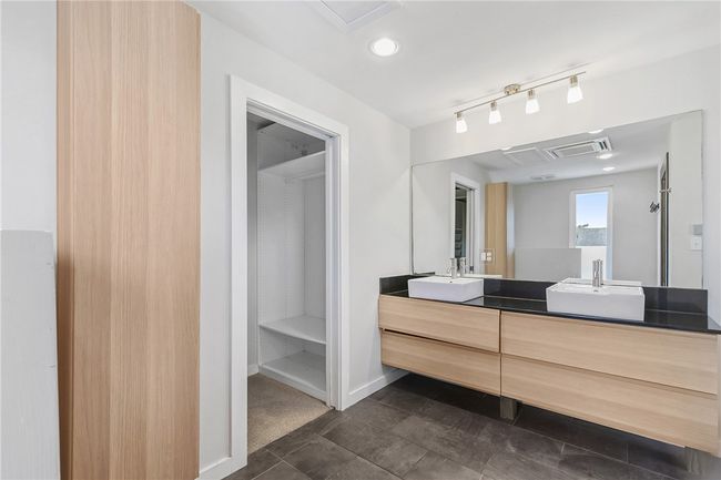 Bathroom with double vanity and baseboards | Image 16