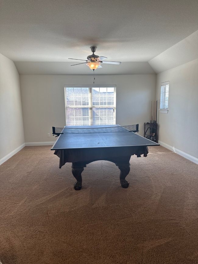 Game room with a wealth of natural light, lofted ceiling, light carpet, and baseboards | Image 24