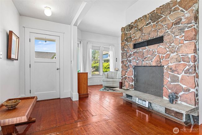 The wood burning fireplace is the centerpiece of the current home. | Image 10