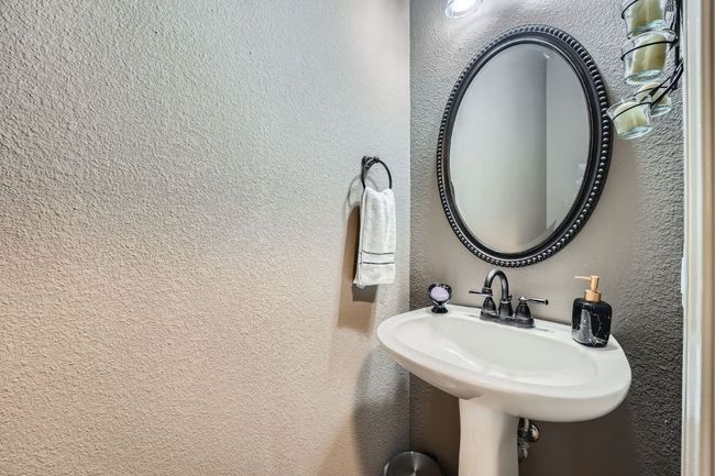 Bathroom featuring a textured wall and a sink | Image 17