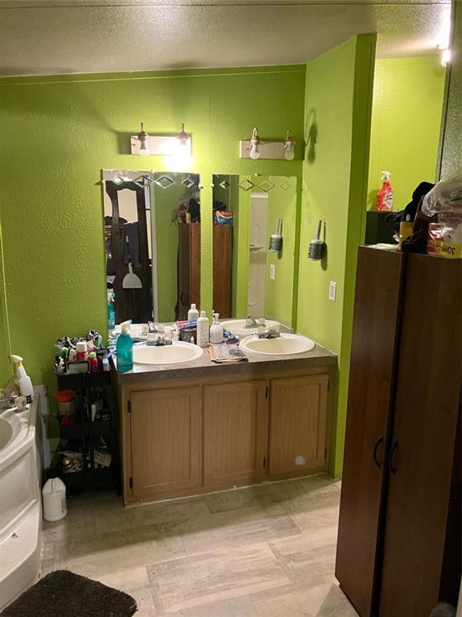 Bathroom with a textured ceiling and double vanity | Image 18
