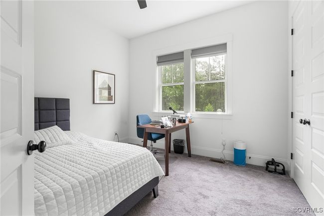 Bedroom with carpet, baseboards, an office area, and ceiling fan | Image 19