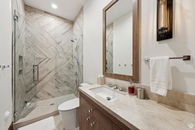Bathroom with toilet, vanity, and a shower stall | Image 96