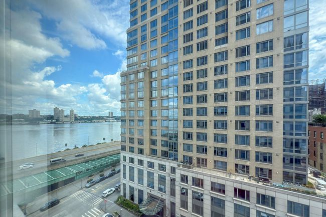 View of building exterior featuring a city view and a water view | Image 12