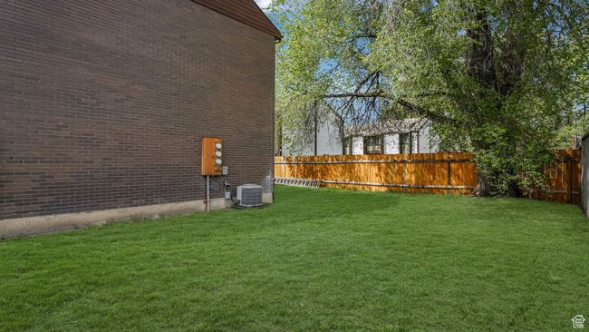 View of yard featuring central AC and a fenced backyard | Image 17