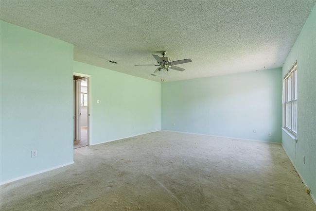 Spare room with carpet flooring, ceiling fan, baseboards, and a textured ceiling | Image 19