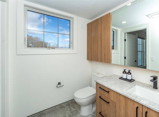This bathroom features a window. | Image 27