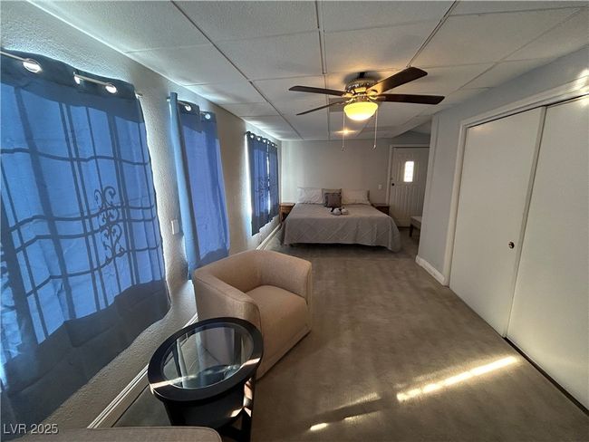 Carpeted bedroom with a paneled ceiling and a ceiling fan | Image 11