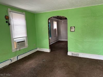 Empty room featuring cooling unit and a textured ceiling | Image 3