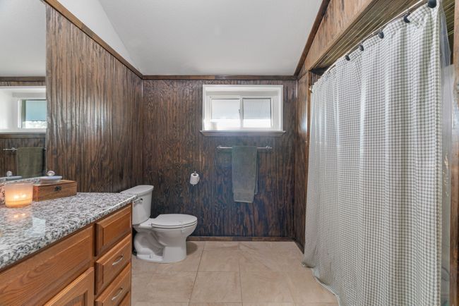 Full bath with vanity, vaulted ceiling, and curtained shower | Image 31