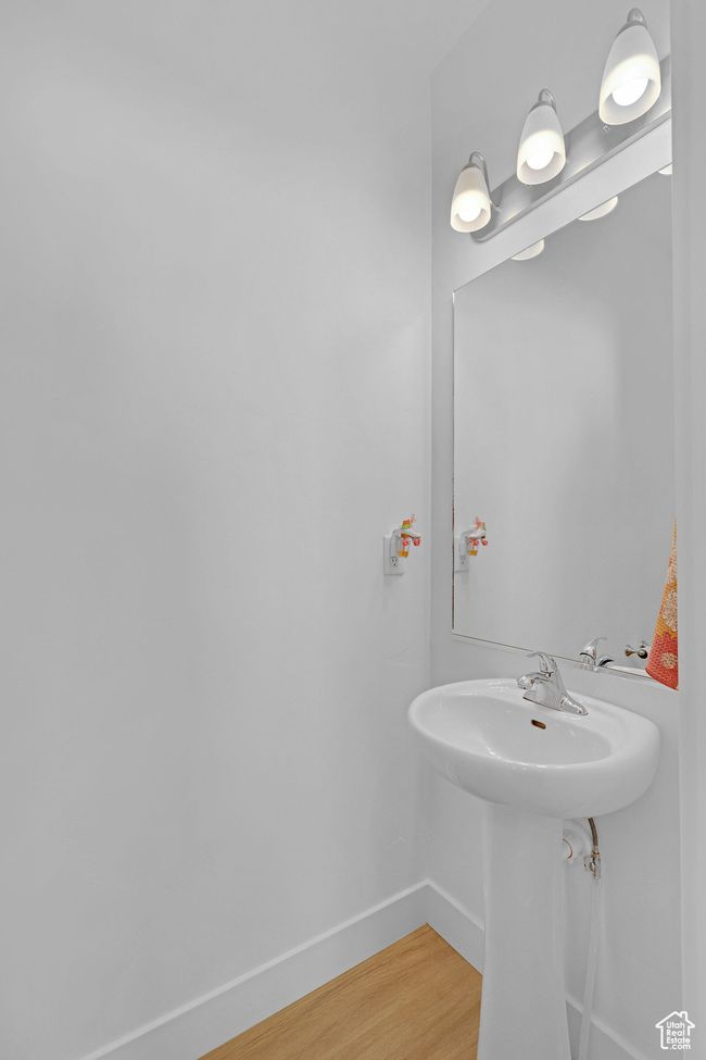 Bathroom featuring baseboards and wood finished floors | Image 10