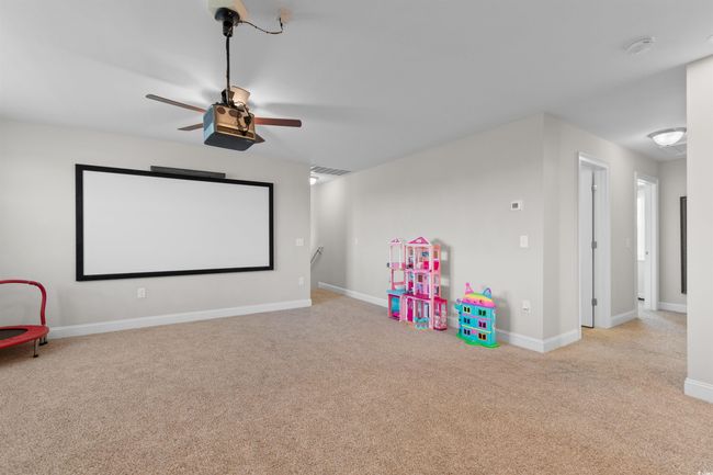Cinema featuring ceiling fan and carpet flooring | Image 31