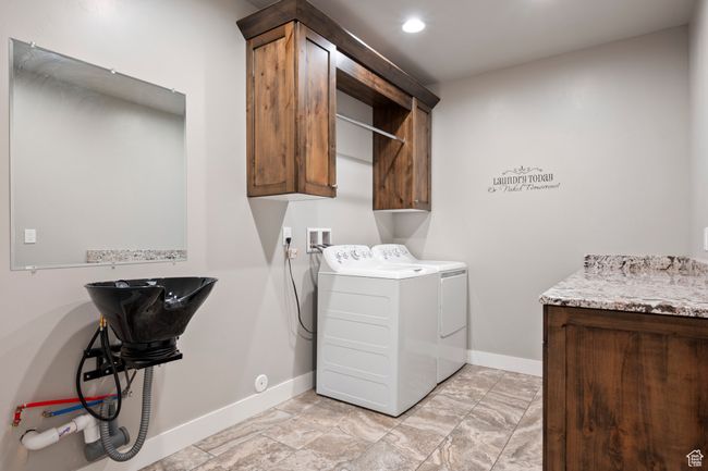 Laundry room featuring washing machine and dryer, baseboards, cabinet space, and recessed lighting | Image 26