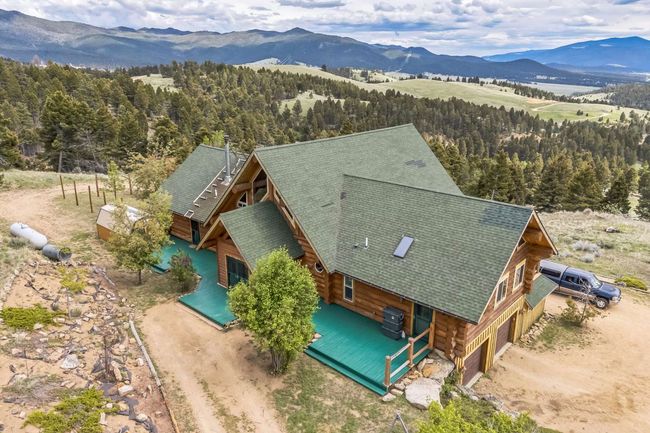 View from above of property with mountains and a forest | Image 5