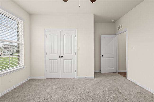 Unfurnished bedroom with carpet, a closet, and ceiling fan | Image 23