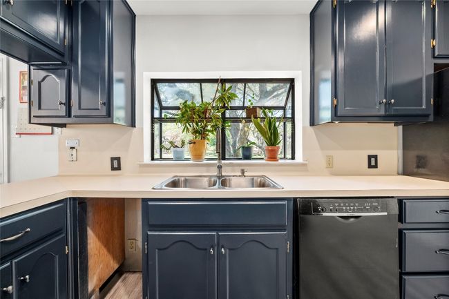 Kitchen with dishwasher and light countertops | Image 10