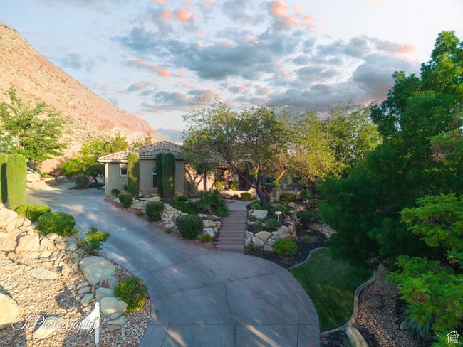 Mediterranean / spanish-style home featuring a mountain view, a tiled roof, stairs, and stucco siding | Image 6