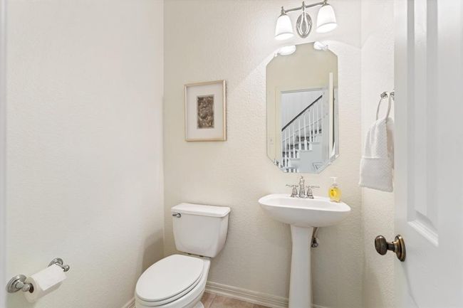 The powder room is tucked away for privacy, yet easily accessible from the foyer. | Image 13
