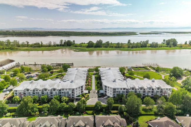 Aerial view of a large body of water and apartment complex | Image 37