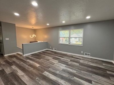 Unfurnished room with dark wood-type flooring and a textured ceiling | Image 2