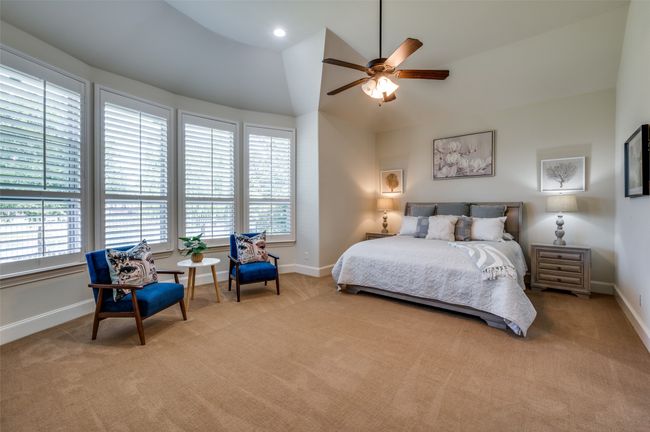 The oversized primary suite features tall ceilings and a charming bump-out with large windows, creating a light-filled and airy retreat. | Image 19
