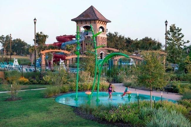 Perfect for family fun, this refreshing pool area features a fun-filled splash pad for the kids. Located within the Riverstone community, this amenity offers a vibrant and inviting atmosphere where residents can enjoy the warm weather in style. | Image 7