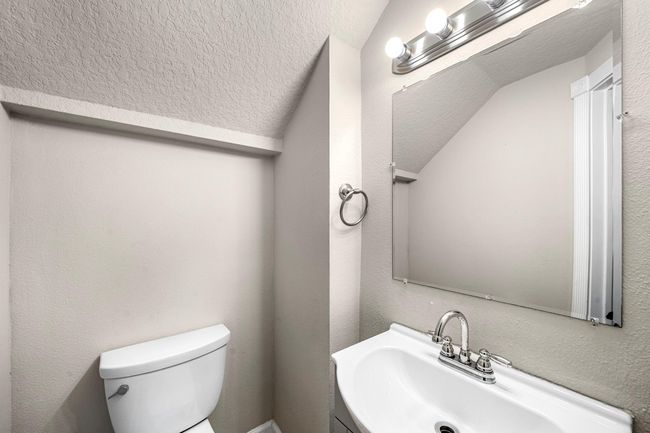 Powder room sits off the family room | Image 18