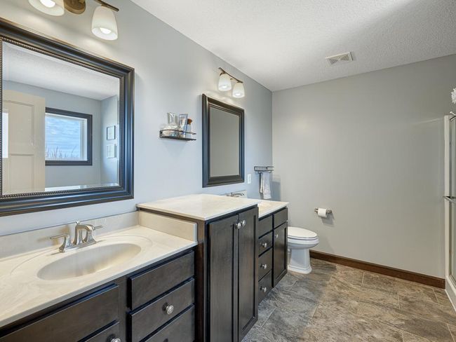 Double sinks and vanity space in the primary bath make getting ready in the morning easy. | Image 21