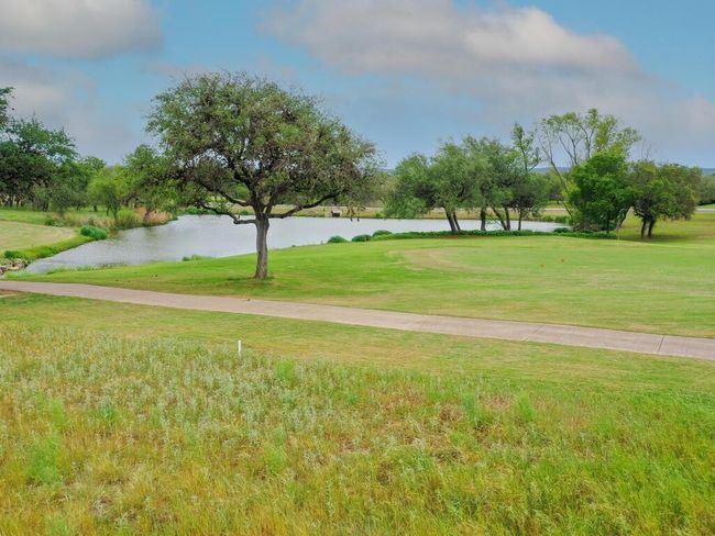 View of property's community featuring a water view and a lawn | Image 4