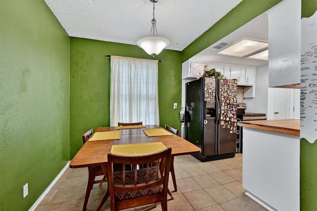 Dining room featuring light tile patterned floors and baseboards | Image 8