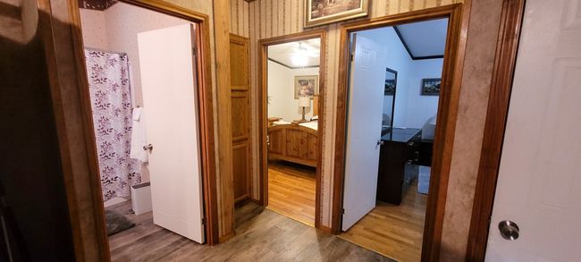 View from kitchen - bathroom is door on far left, with secondary bedrooms to the center and right. | Image 8