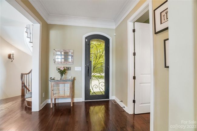 Bright and open floor plan with beautiful flooring, rich molding, arched doorways, and amazing views | Image 5