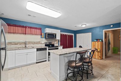 Kitchen with island and granite countertops | Image 2