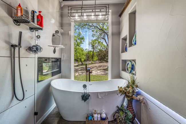 Full bath featuring a chandelier and a freestanding tub | Image 11