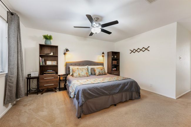 Bedroom with carpet floors, a ceiling fan, and baseboards | Image 18