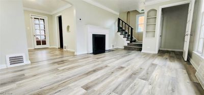 Unfurnished living room with light hardwood / wood-style flooring and ornamental molding | Image 2