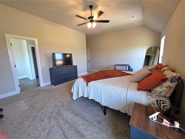 Bedroom featuring carpet floors, lofted ceiling, and ceiling fan | Image 20