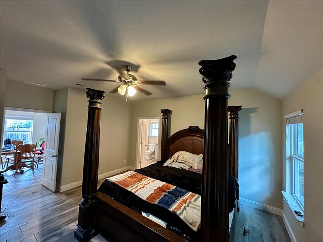 Bedroom with wood finished floors, ensuite bath, and a ceiling fan | Image 31