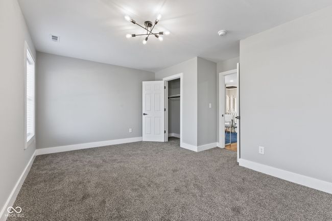 BR2 featuring baseboards, an inviting chandelier, visible vents, and carpet | Image 23